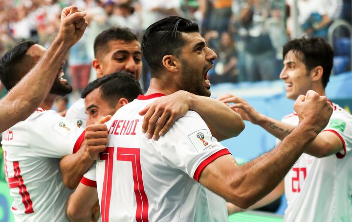 Mehdi Taremi of Iran and his team-mates celebrate their goal during the 2018 FIFA World Cup Russia group B match against Morocco