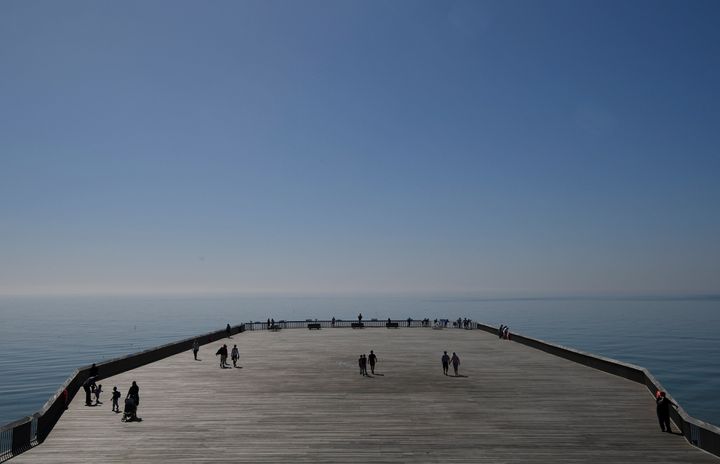 Visitors enjoy the weather as they walk on Hastings Pier. The attraction won the prestigious Stirling Prize for architecture last year.
