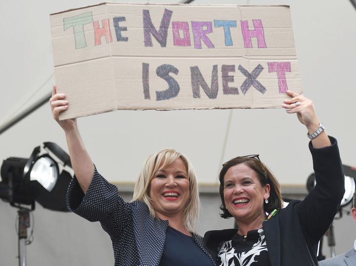 Michelle O'Neill leader of Sinn Fein in Northern Ireland, left, holds up a placard as she celebrates the result of the abortion referendum in the Republic last month.