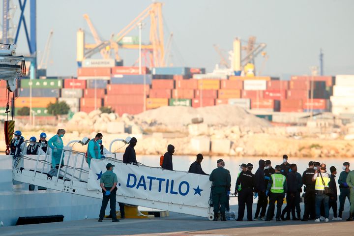 Migrants disembark from the Italian coast guard boat the Dattilo at the port of Valencia on June 17.