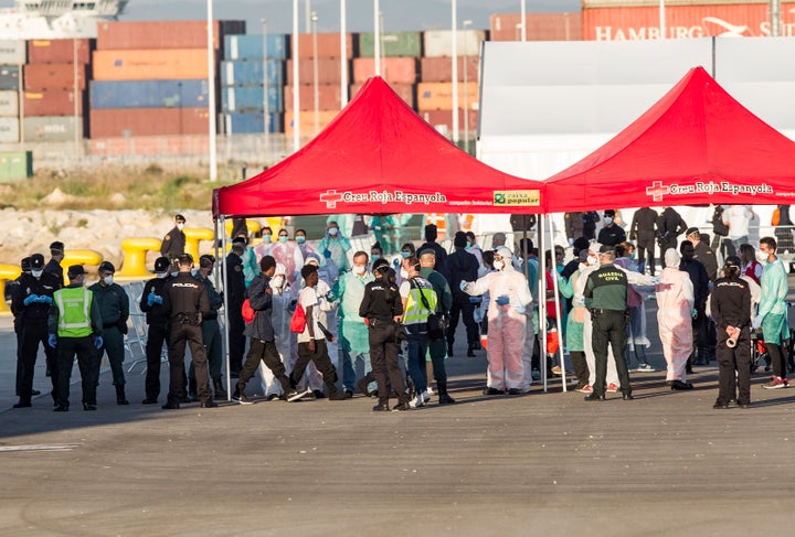 Migrants disembark from the Italian navy vessel, the Dattilo at the port of Valencia.