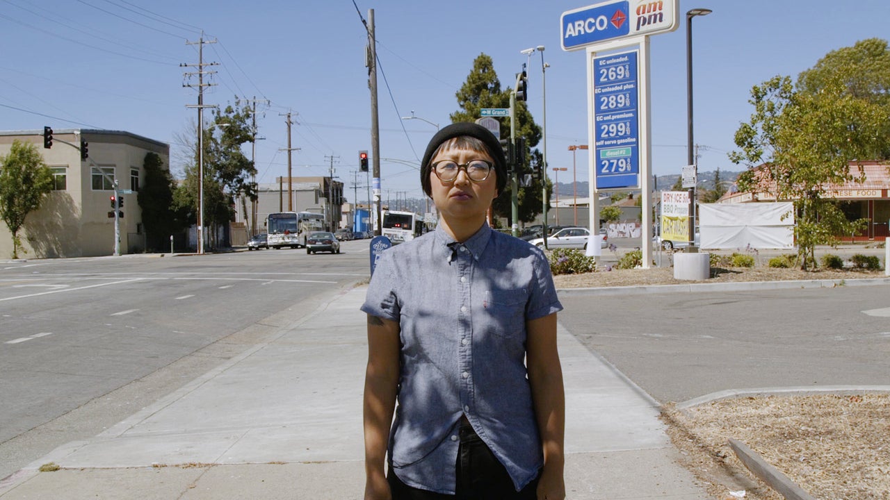 Nat in Oakland, California, reading a 1970s letter from an Oakland woman who writes about working at a gas station.