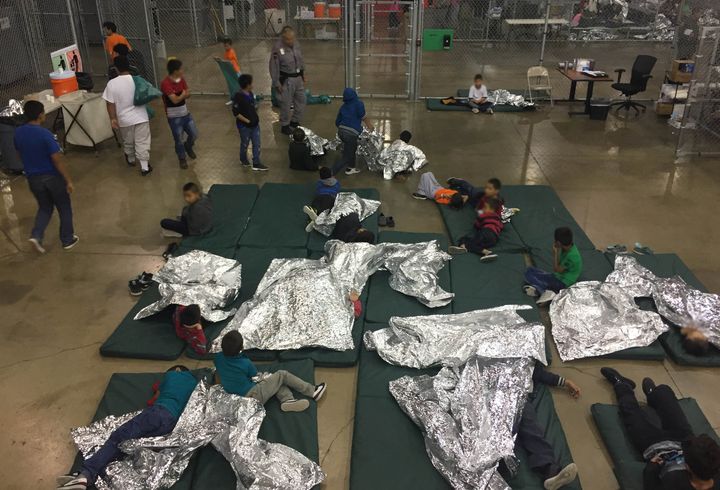 Children lie on sleeping pads with space blankets at the Rio Grande Valley Centralized Processing Center in Rio Grande City, Texas.
