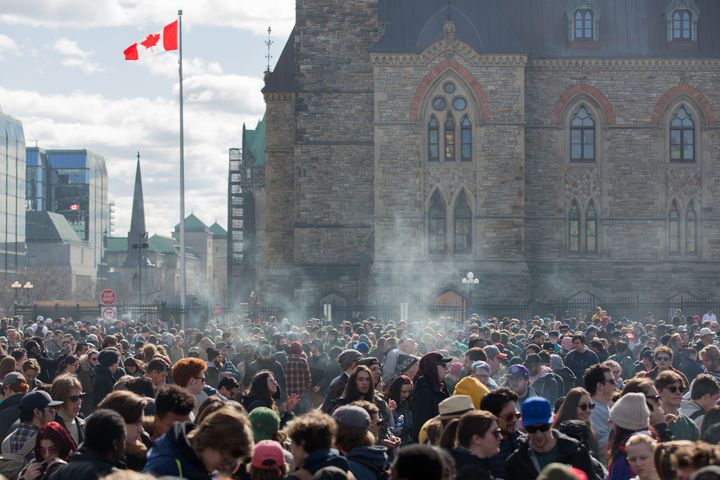 Smoke lingers over Parliament Hill in Ottawa, Ontario, as people smoke marijuana during the annual 4/20 rally on April 20, 2018.