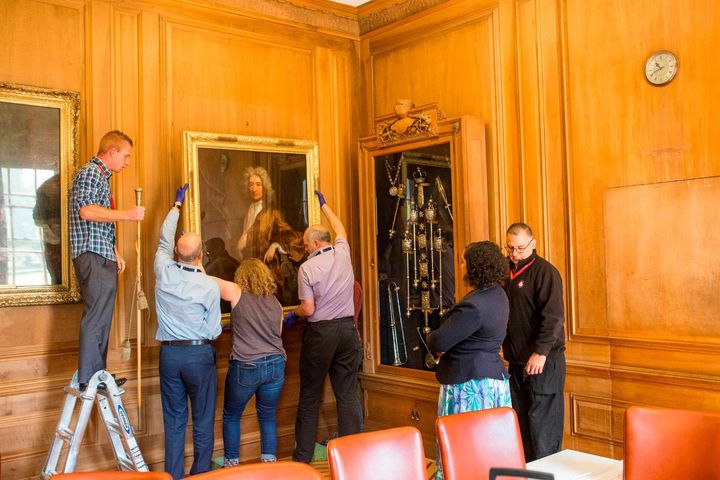 The portrait of Edward Colston being removed from a City Hall office in Bristol.