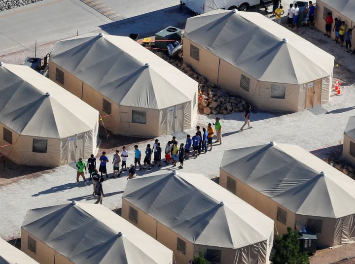 Immigrant children now housed in a tent encampment under the new 'zero tolerance' policy by the Trump administration are shown walking in single file at the facility near the Mexican border in Texas