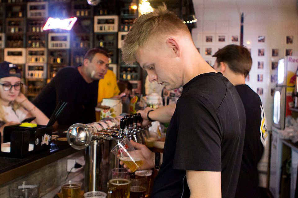 The cheap beer at Vitalii's pub attracts tourists, who are 'significantly more willing to spend'.