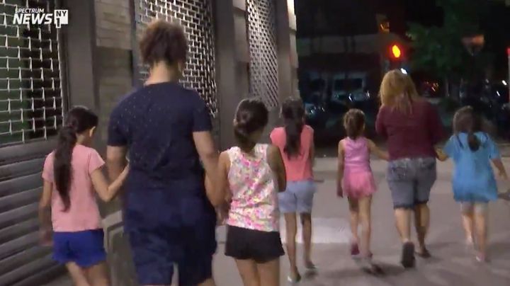 Spectrum News NY1 video shows children being taken into a foster care facility in New York City early Wednesday.