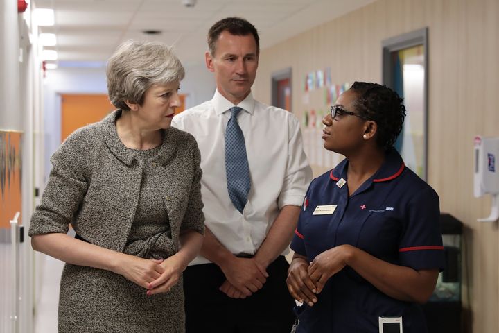 Theresa May with health secretary Jeremy Hunt meet a nurse at the Royal Free Hospital 