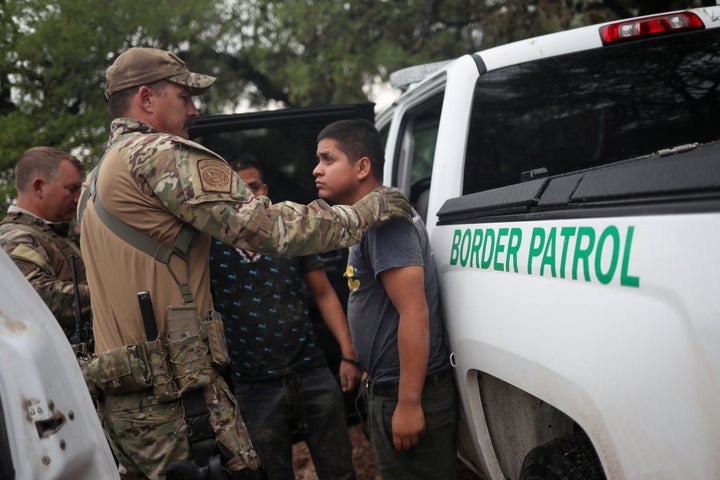 Members of the Border Patrol Search, Trauma, and Rescue (BORSTAR) unit apprehend migrants from Guatemala near Falfurrias, Texas, on June 19, 2018.