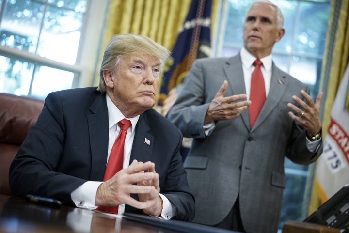 President Donald Trump signs an executive order on immigration in the Oval Office on June 20, 2018.