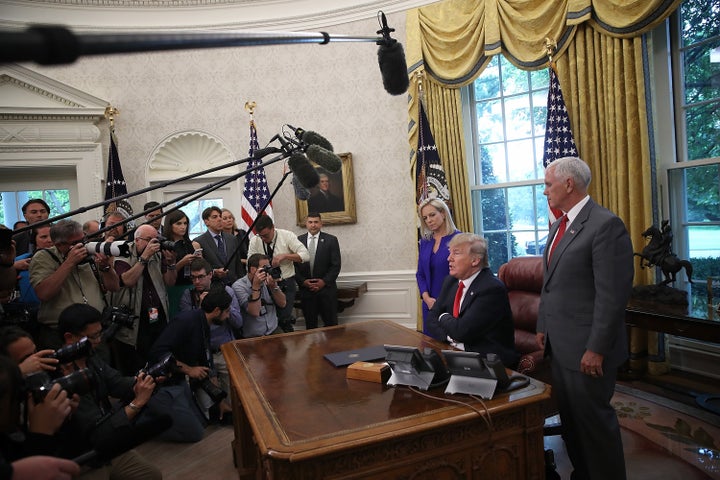 President Donald Trump, accompanied by Department of Homeland Security Secretary Kirstjen Nielsen and Vice President Mike Pence, answers questions about the immigration executive order he signed on June 20, 2018.