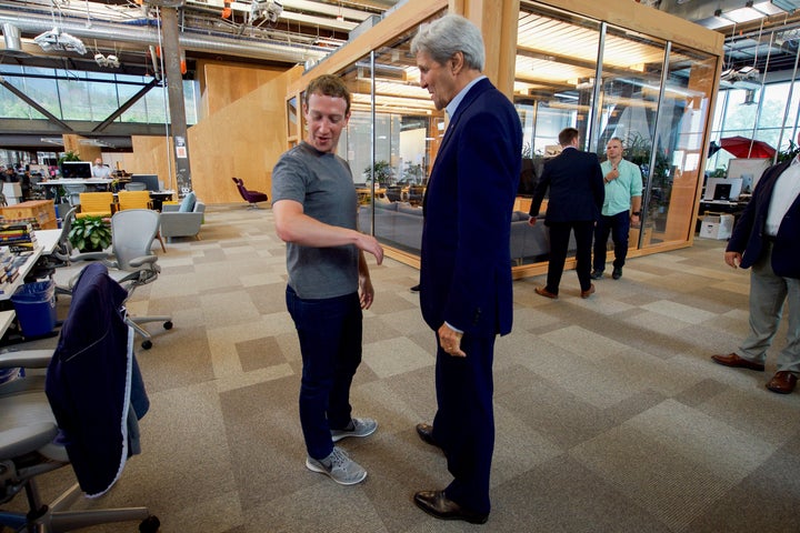 Former Secretary of State John Kerry speaks with Facebook CEO Mark Zuckerberg at Facebook headquarters in 2016 in Menlo Park, California.