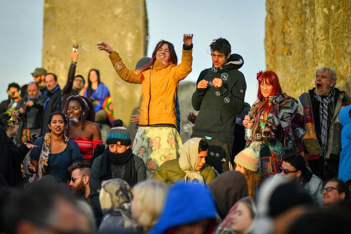 A woman dances on the stones as the sun rises 