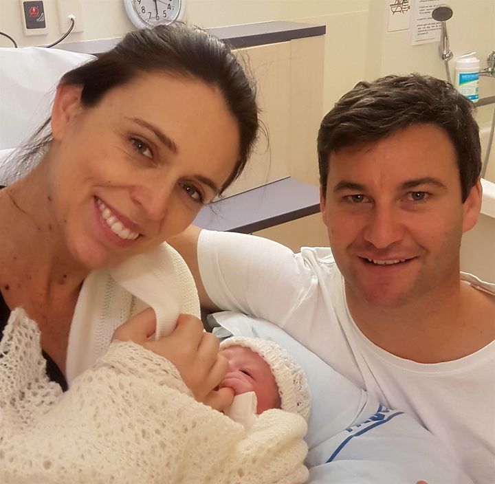 New Zealand Prime Minister Jacinda Ardern and partner Clarke Gayford pose for a photo with their new baby girl on 21 June 2018