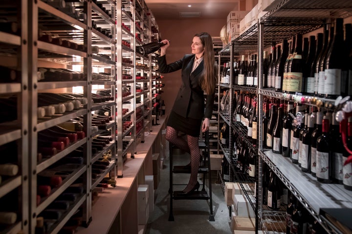 Victoria James picks bottles from the pink wine cellar at Cote.