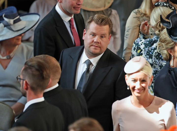 Corden inside St. George's Chapel at Windsor Castle in one of the photos where he sort of looks miserable. 