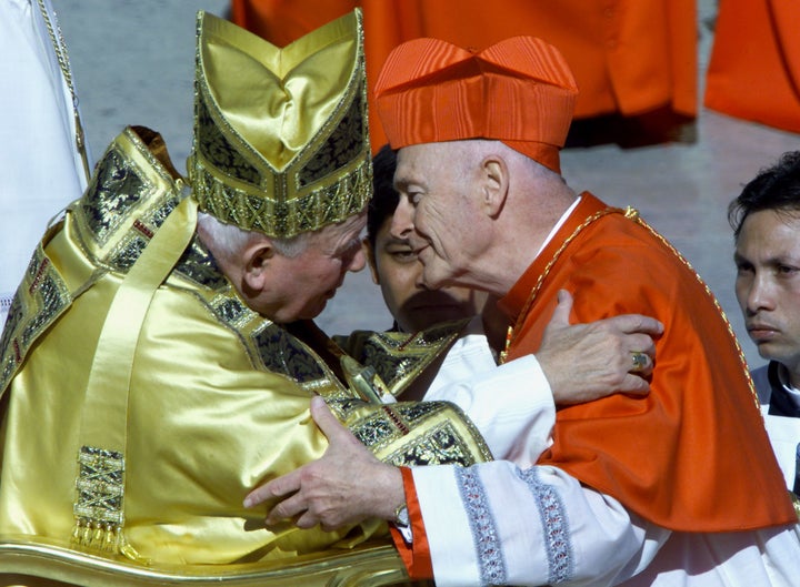 Theodore McCarrick greets Pope John Paul II after he received the red cap of a cardinal during a ceremony