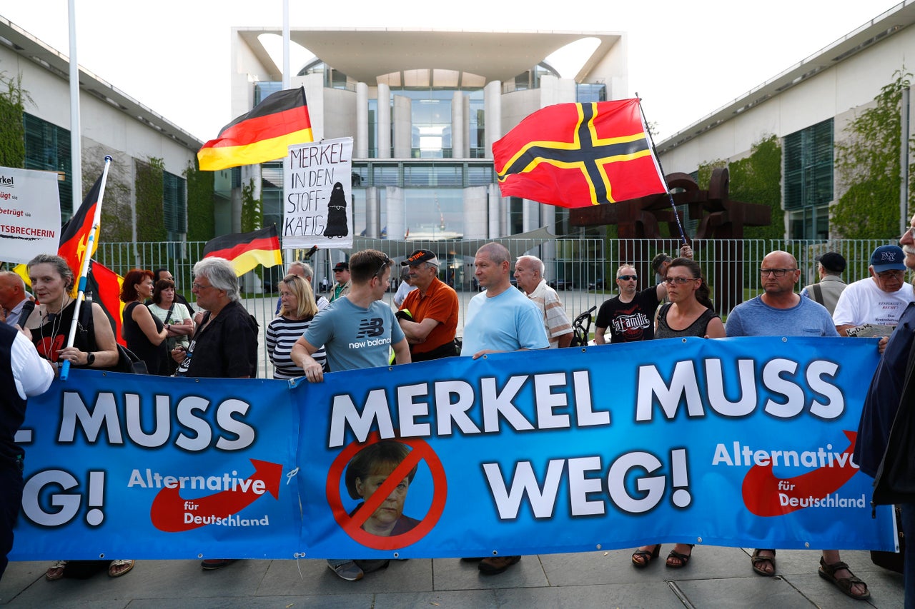 Supporters of the Alternative for Germany (AfD) party stage a protest in Berlin with signs reading "Merkel Must Go," May 9, 2018.