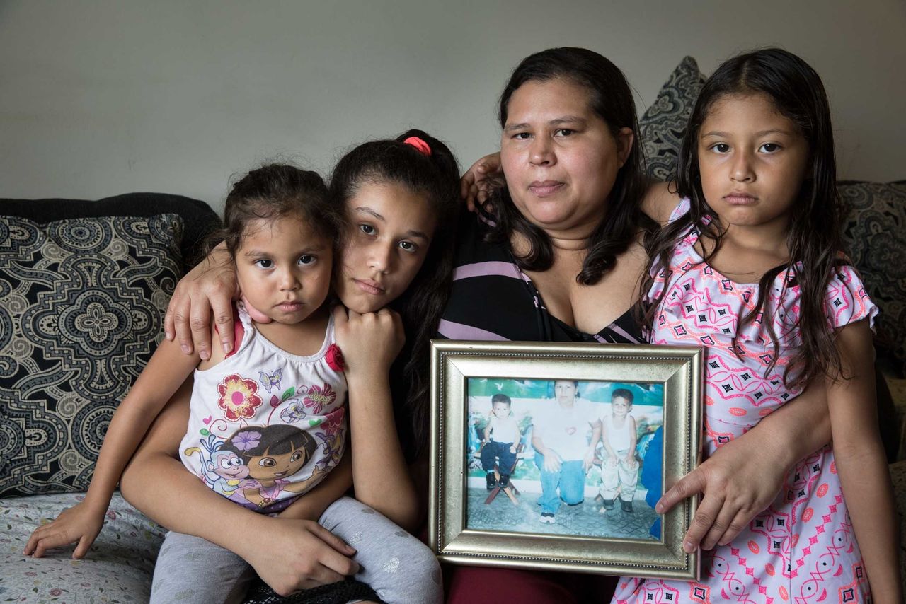 Aracely Martinez Yanez is pictured with her three daughters: Alyson, 4, Emely, 11 and Gabriela, 7. She holds her only photograph of her murdered sons: Daniel, 4, and Juancito, 6.