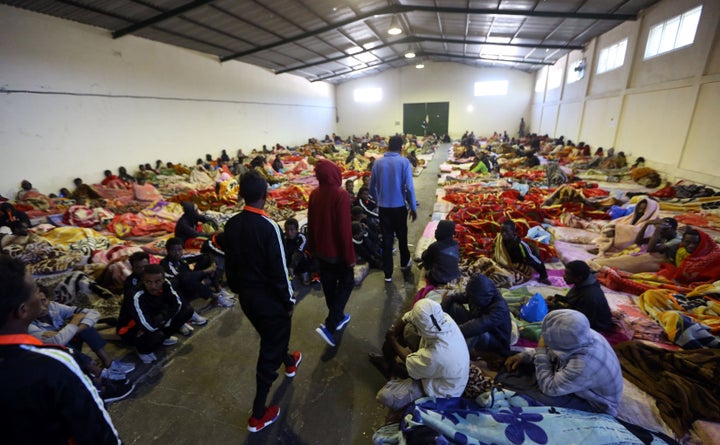 A picture taken on Dec. 11, 2017, shows African migrants sitting in a shelter at the Tariq Al-Matar migrant detention center on the outskirts of the Libyan capital, Tripoli.