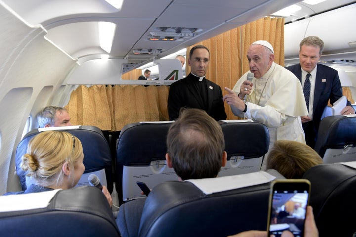 Pope Francis talks with journalists aboard a plane, at the end of his visit to Geneva on June 21.