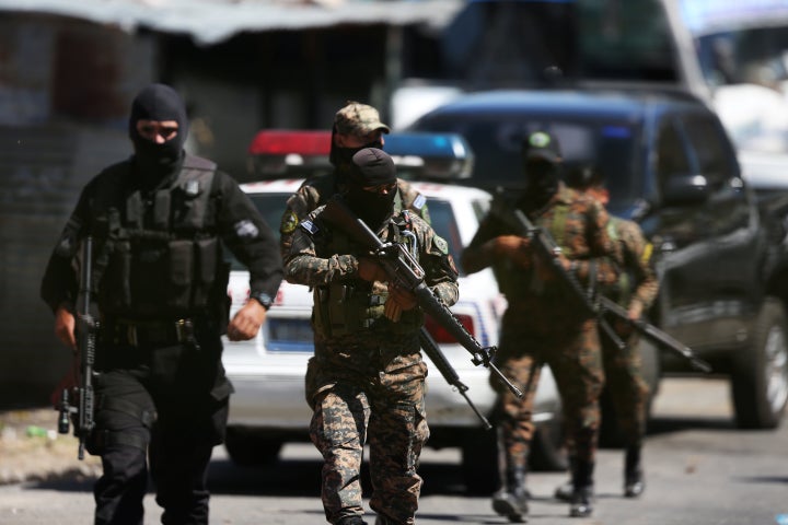 Salvadoran policemen and army soldiers secure the area where a policeman and two gang members were killed in San Salvador, El Salvador, on Feb. 2, 2018.