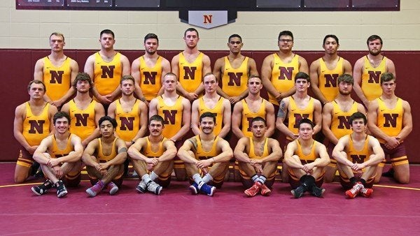 Horn poses with fellow teammates competing for the Northern State University wrestling team.