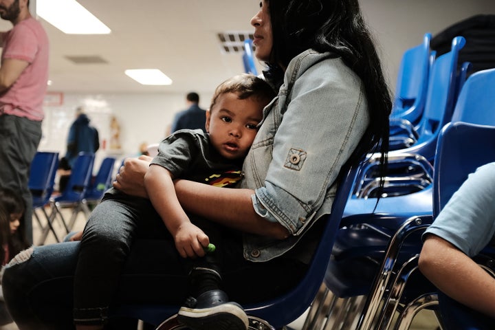 A woman who identified herself as Jennifer sits with her son at the Catholic Charities Humanitarian Respite Center in McAllen, Texas, on Thursday after crossing the U.S.-Mexico border. 