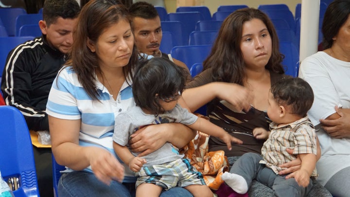 Mothers and children wait to be assisted by volunteers in a humanitarian center in the border town of McAllen, Texas, on June 14, 2018.