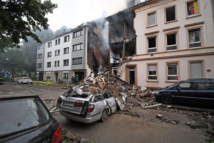 A car is covered by debris of a house that has exploded in the night in Wuppertal, western Germany.