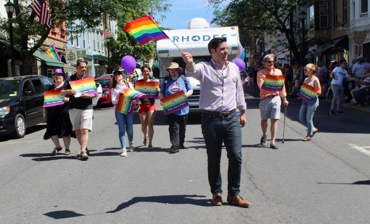 Democrat Gareth Rhodes marches in the pride parade in Hudson, N.Y., on June 16, with his "Rhodes Trip" Winnebago picking
