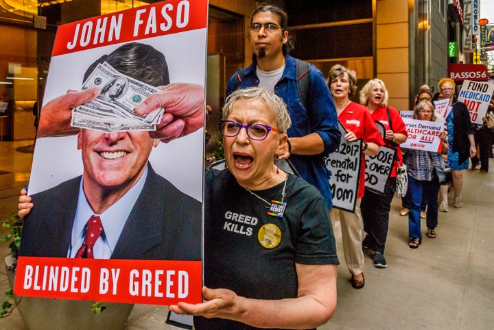 Residents of New York's 19th Congressional District protest outside a Manhattan fundraiser for Rep. John Faso (R) in July 201