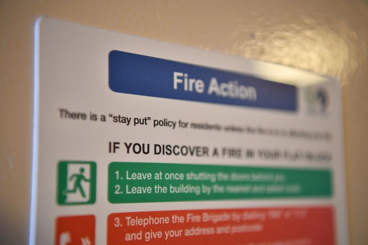 A fire action sign inside a block near the Grenfell Tower