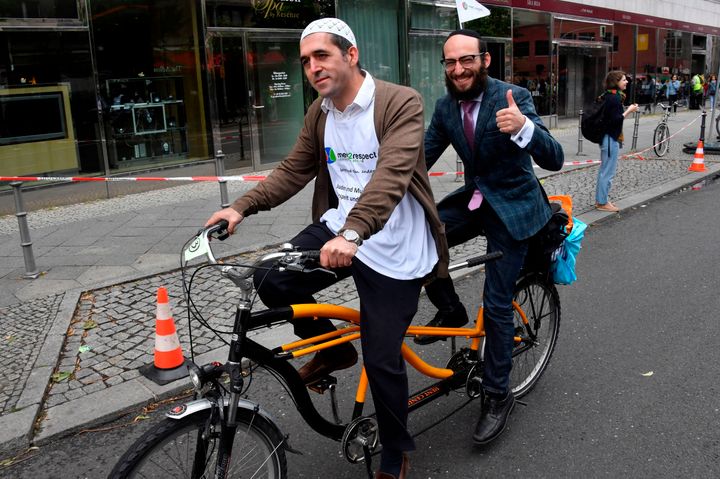 Imam Osman Oers (front) and Rabbi Akiva Weingarten participate in an interfaith bicycle ride in Berlin on June 24, 2018.
