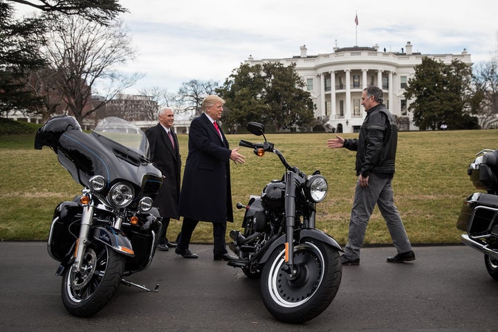 President Donald Trump (center) greets Matthew Levatich (right), CEO of Harley-Davidson Inc., outside the White House in February 2017 as Vice President Mike Pence smiles.