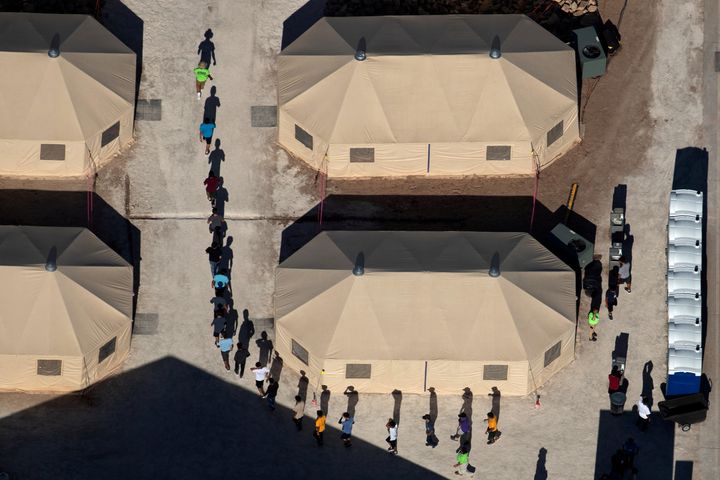 Immigrant children are led in single file between tents at a detention facility next to the Mexican border in Tornillo, Texas, on June 18, 2018. 