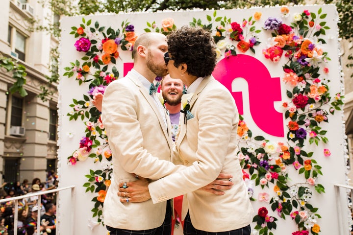 Berk (rear) officiated the wedding of Andrew Pharis and Guillermo Irias during the New York Pride parade on Sunday.