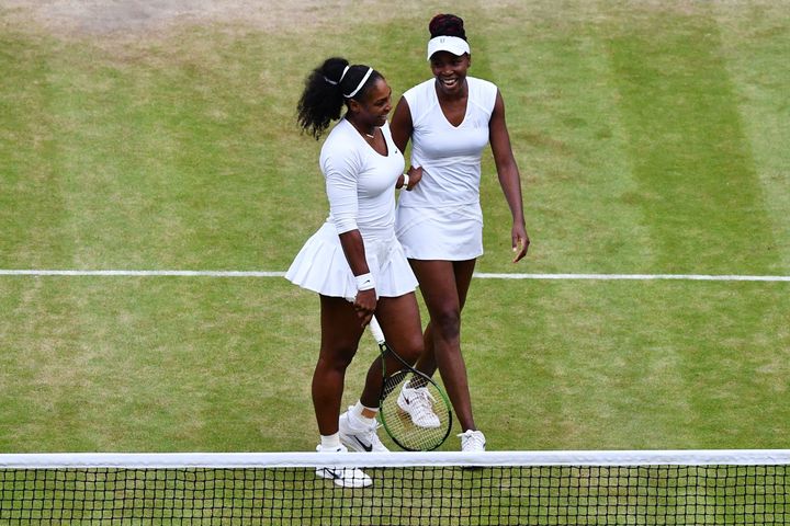 Serena Williams (L) and Venus Williams (R) win the women's doubles final on the thirteenth day of the 2016 Wimbledon Championships.