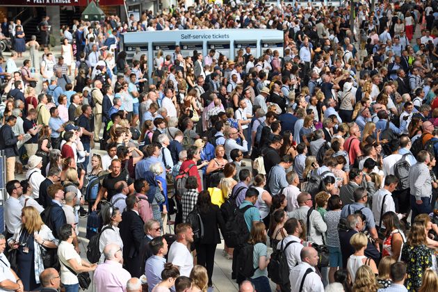 Commuters at Waterloo Station, London, as rail services to and from the railway station were disrupted for a second successive day on Tuesday after a fire under a train.