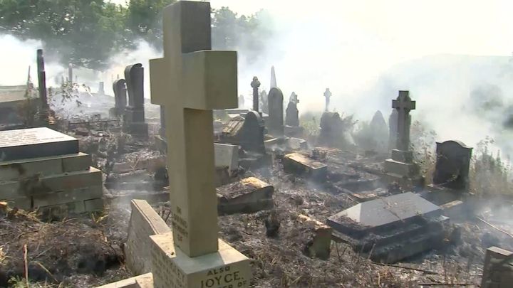 Graves were shrouded in thick smoke as the wildfire flourished in the cemetery outside Manchester on Tuesday.