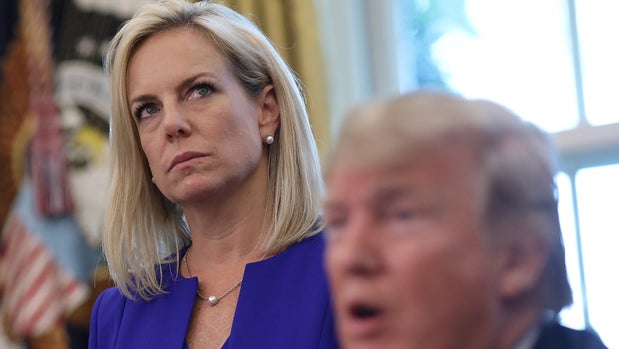 WASHINGTON, DC - JUNE 20:  Department of Homeland Security Secretary Kirstjen Nielsen (L) listens as U.S. President Donald Trump answers questions after signing an executive order that will end the practice of separating family members who are apprehended while illegally entering the United States on June 20, 2018 in Washington, DC. The order would detain parents and children together. (Photo by Win McNamee/Getty Images)