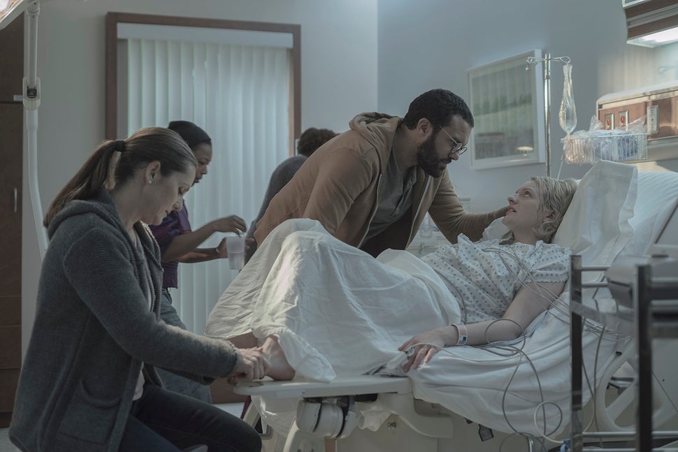 In a flashback scene, June prepares to deliver her first child, Hannah, with her husband by her side. Back in Gilea