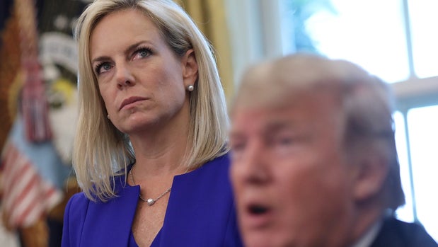 WASHINGTON, DC - JUNE 20:  Department of Homeland Security Secretary Kirstjen Nielsen (L) listens as U.S. President Donald Trump answers questions after signing an executive order that will end the practice of separating family members who are apprehended while illegally entering the United States on June 20, 2018 in Washington, DC. The order would detain parents and children together. (Photo by Win McNamee/Getty Images)