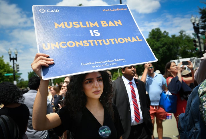 People protest Trump's travel ban outside the Supreme Court on June 26, 2018.