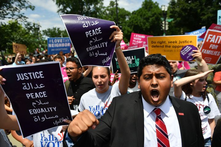 People protest the Muslim travel ban outside of the US Supreme Court in Washington, DC on June 26, 2018. 