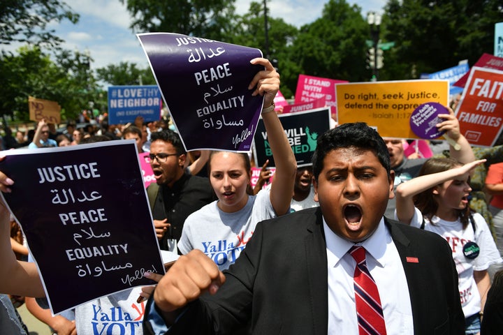 People protest the Muslim travel ban outside of the US Supreme Court in Washington, DC on June 26, 2018. 