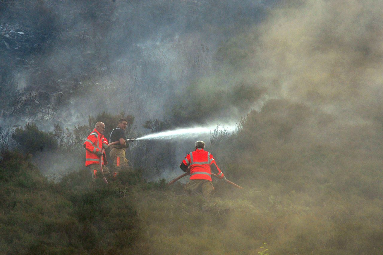 Firefighters are still battling the fire amid balmy heatwave temperatures.