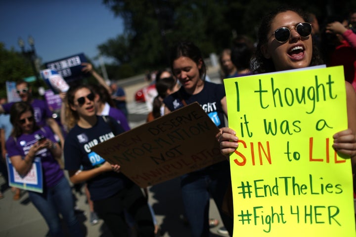 Protesters demonstrate outside the Supreme Court as the court issues a ruling on a California law related to abortion issues on June 26, 2018, in Washington, D.C.