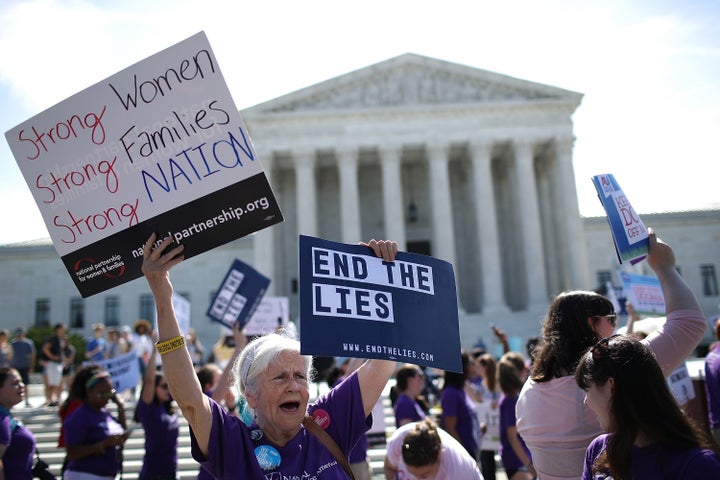 Protesters demonstrate outside the Supreme Court as the court issues a ruling on a California law related to abortion issues on June 26, 2018, in Washington, D.C.